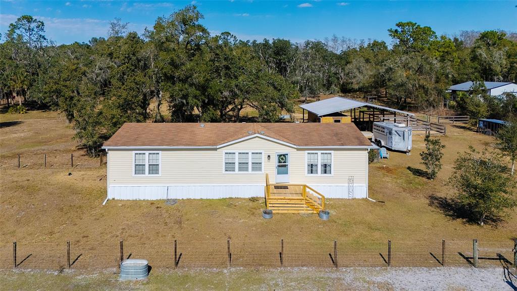 2100 East Kicklighter Road Lake Helen, FL 32744 - Photo 3 of 61 aerial view of a house with a yard and trees in the background