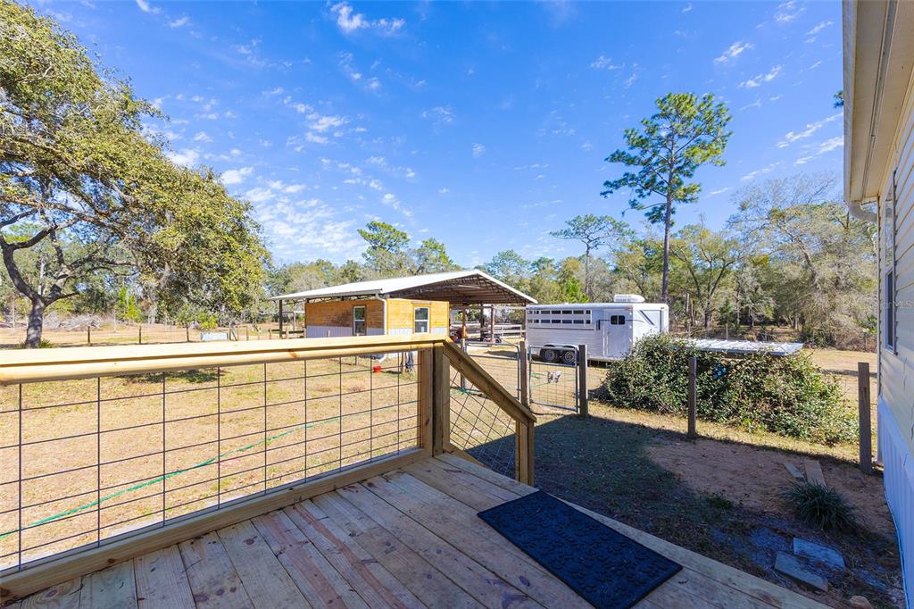 2100 East Kicklighter Road Lake Helen, FL 32744 - Photo 40 of 61 a view of a chairs and table on the wooden deck
