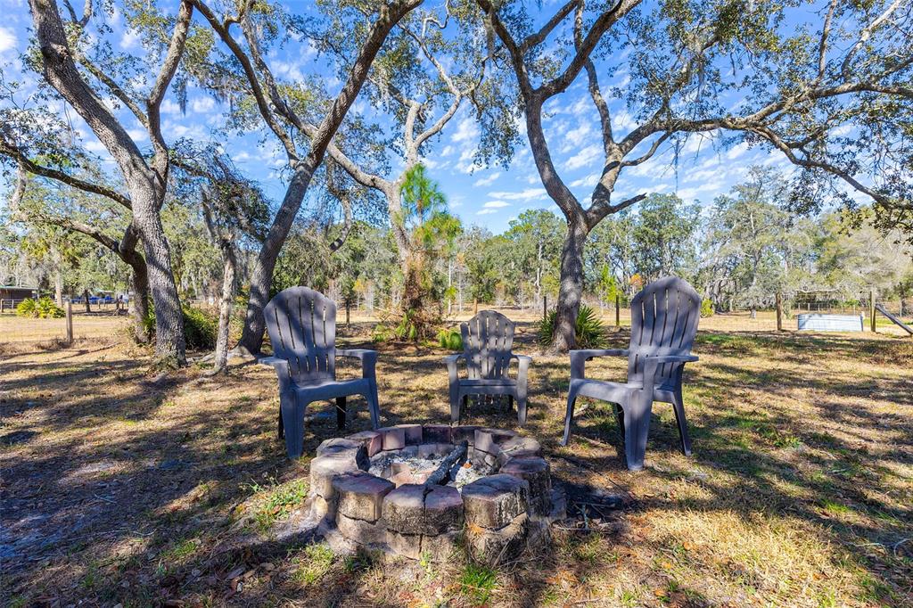 2100 East Kicklighter Road Lake Helen, FL 32744 - Photo 42 of 61 a view of a tables and chairs on the deck