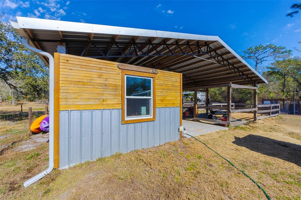 2100 East Kicklighter Road Lake Helen, FL 32744 - Photo 44 of 61 a view of a patio with table and chairs with wooden floor and plants