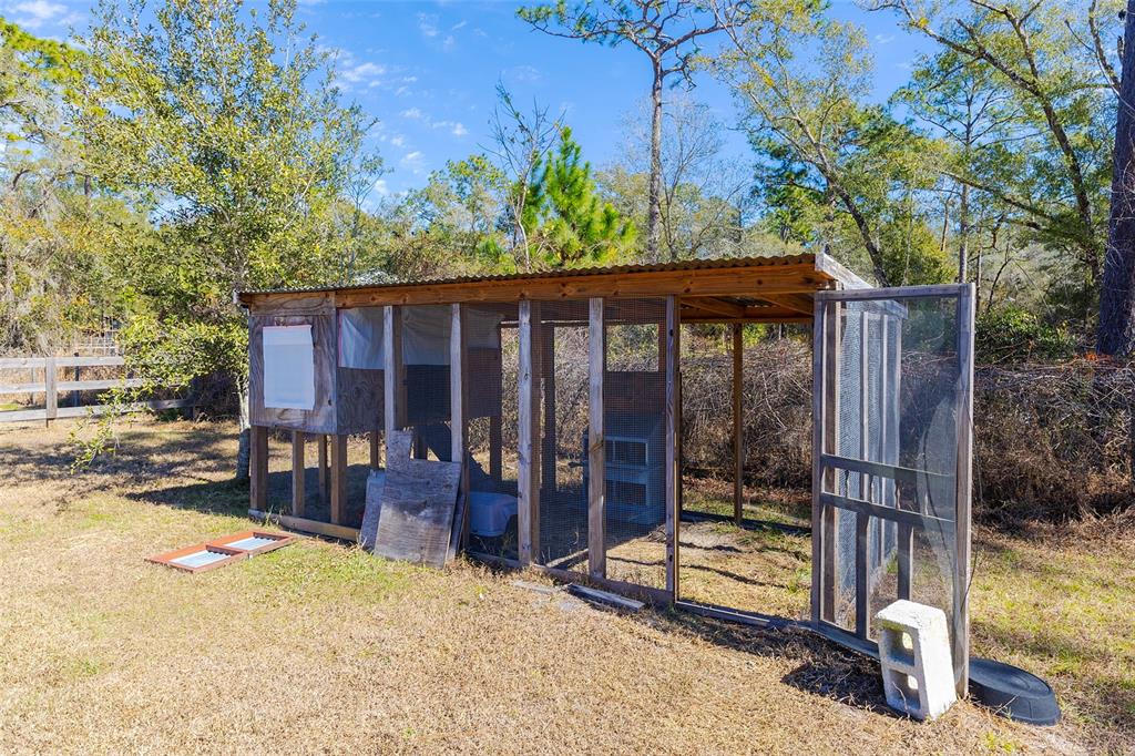 2100 East Kicklighter Road Lake Helen, FL 32744 - Photo 48 of 61 a view of backyard with large trees and wooden fence
