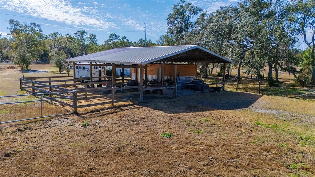 2100 East Kicklighter Road Lake Helen, FL 32744 - Photo 50 of 61 a backyard of a house with barbeque oven table and chairs
