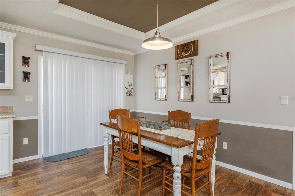 2100 East Kicklighter Road Lake Helen, FL 32744 - Photo 9 of 61 a view of a dining room with furniture and a chandelier