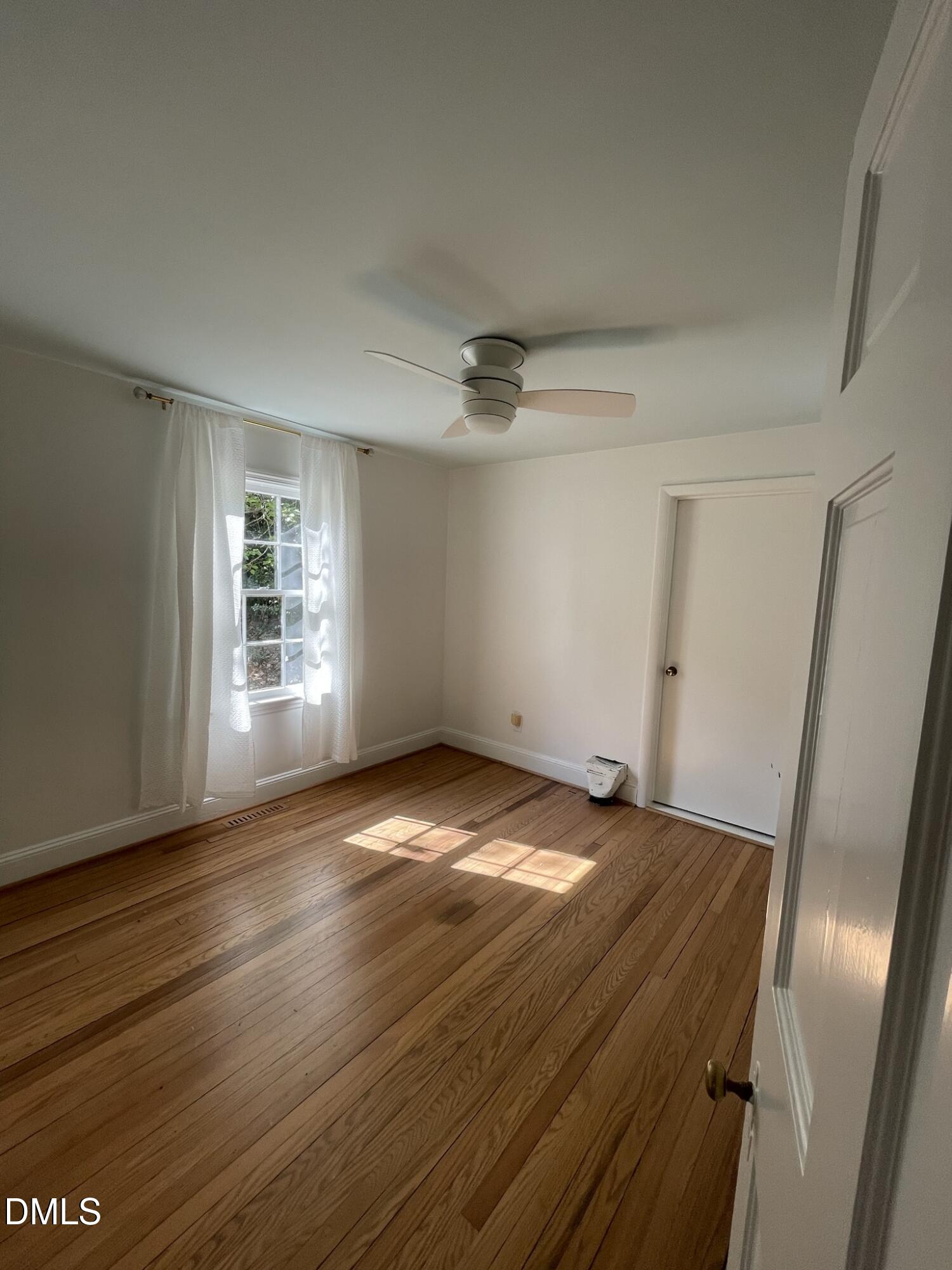 1009 Canterbury Road Raleigh, NC 27607 - Photo 23 of 31 a view of empty room with wooden floor