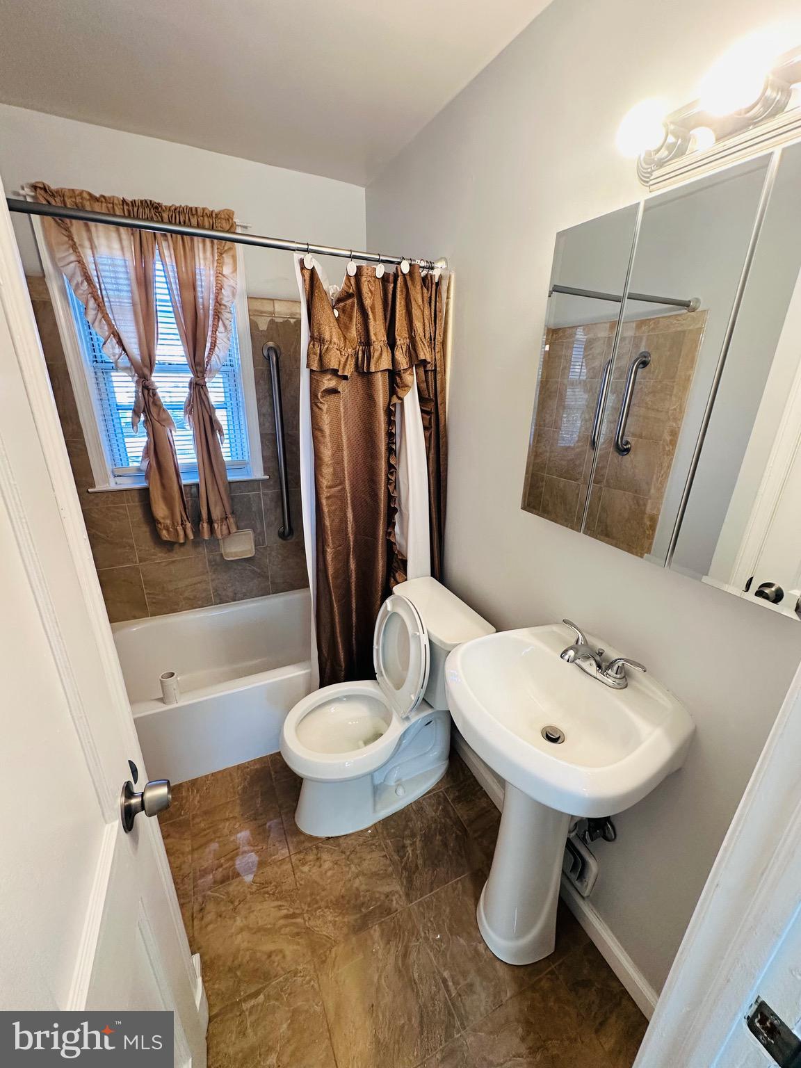 4728 Chatford Avenue Baltimore, MD 21206 - Photo 20 of 36 a bathroom with a sink toilet and a mirror