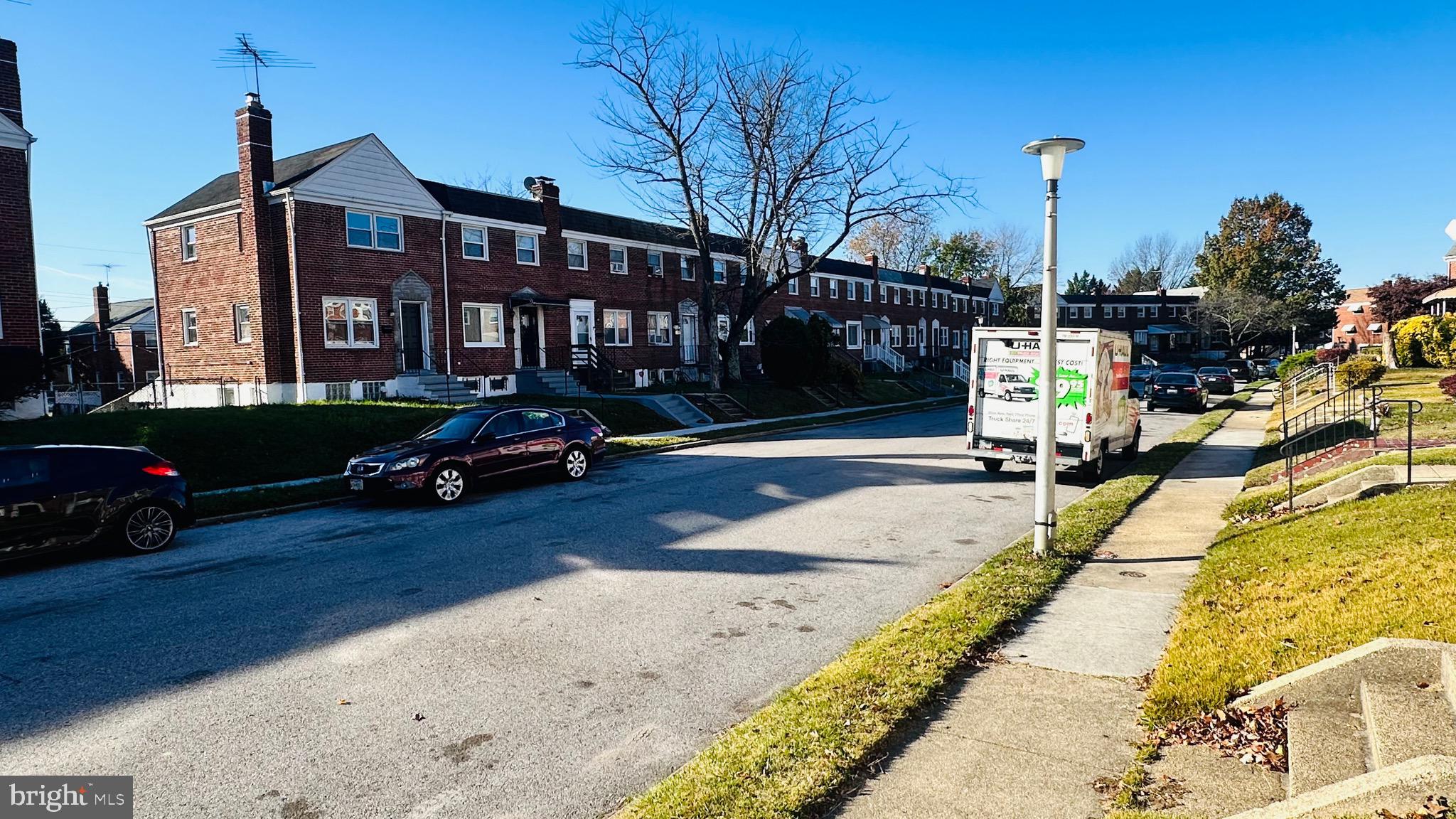 4728 Chatford Avenue Baltimore, MD 21206 - Photo 2 of 36 a view of multiple houses with cars parked on the roadside