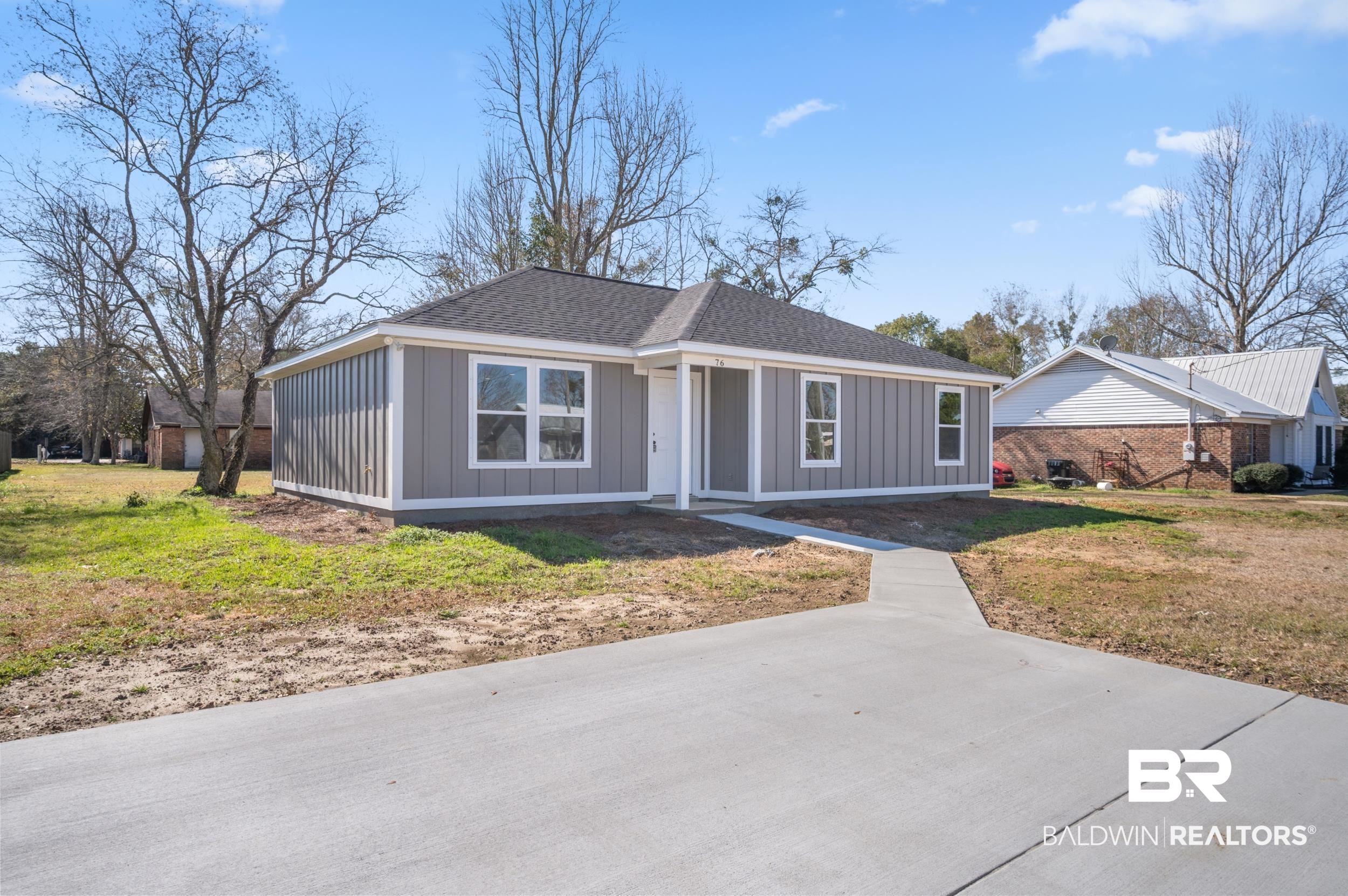 76 Fincher Lane Loxley, AL 36551 - Photo 2 of 33 Ranch-style house with board and batten siding, a front lawn, and roof with shingles