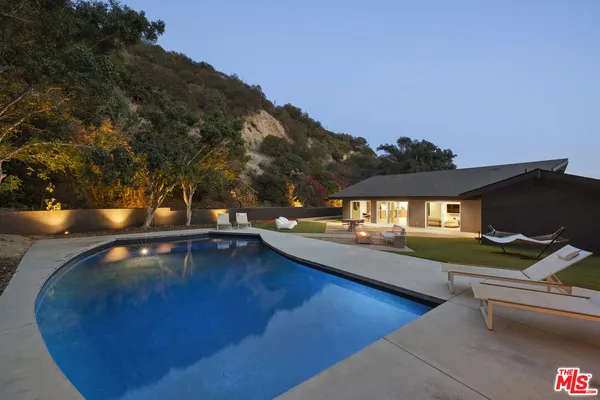 a view of a swimming pool with an outdoor seating