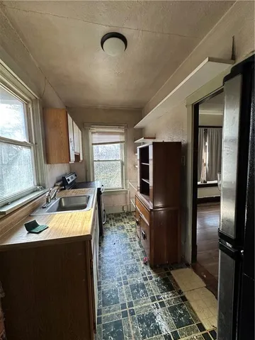 a kitchen with a refrigerator sink and stove