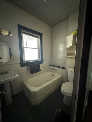 a bathroom with a sink a toilet and a bathtub