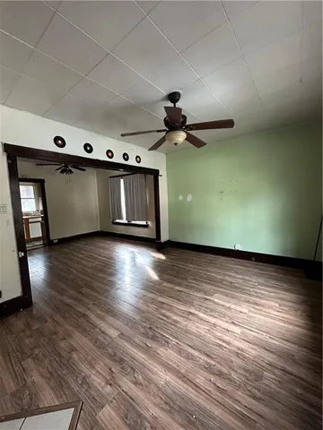 a view of a room with wooden floor