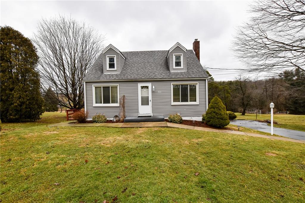 a view of a house with a backyard