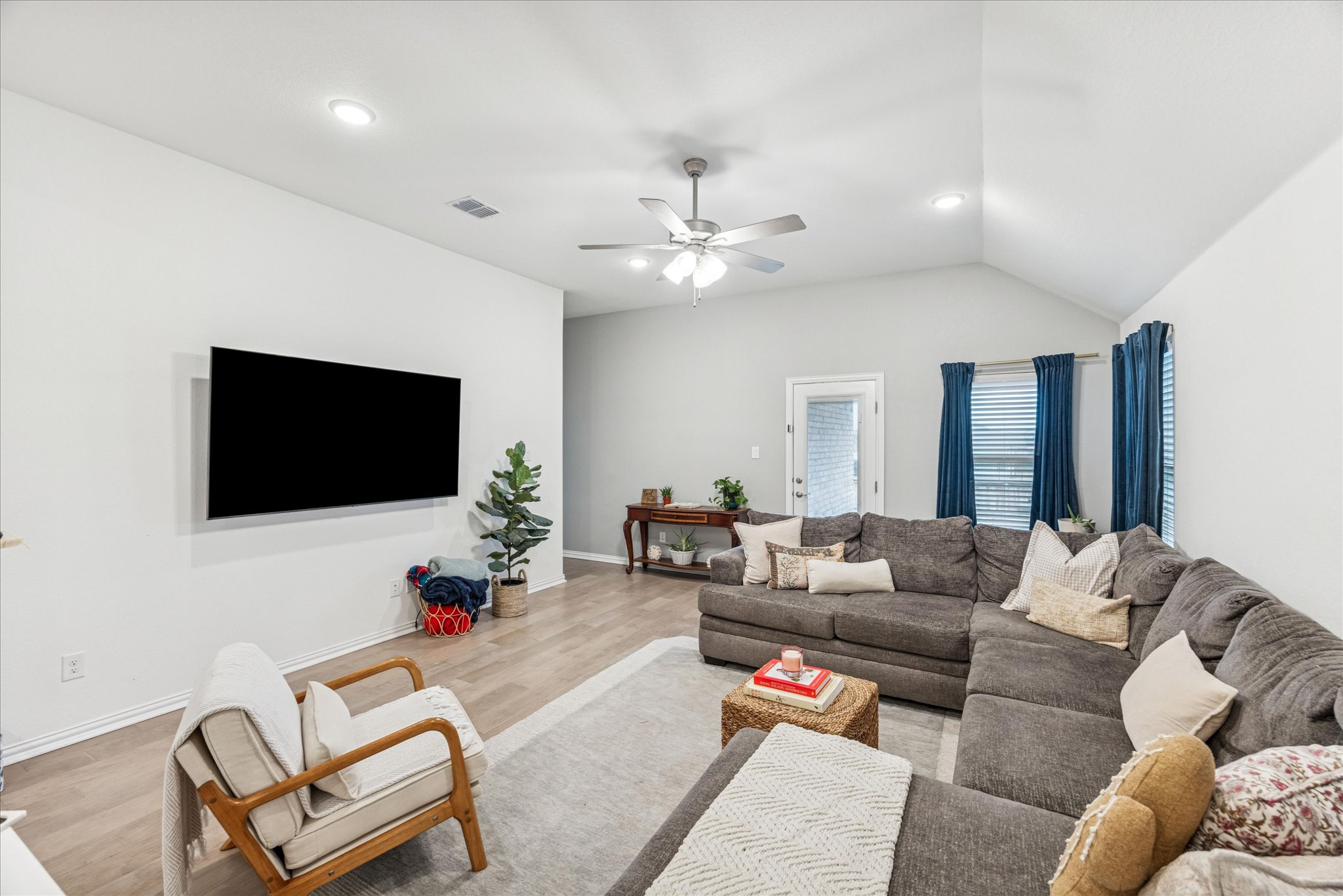 540 Sugar Cane Buda, TX 78610 - Photo 4 of 11 Living room with wood finished floors, a ceiling fan, recessed lighting, and vaulted ceiling