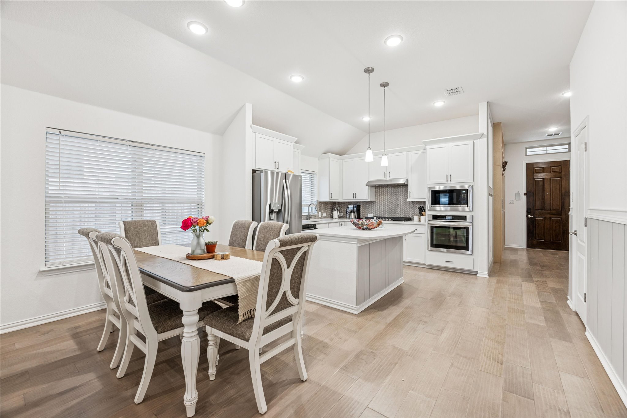 540 Sugar Cane Buda, TX 78610 - Photo 5 of 11 Dining room with recessed lighting, light wood-style floors, healthy amount of natural light, and lofted ceiling