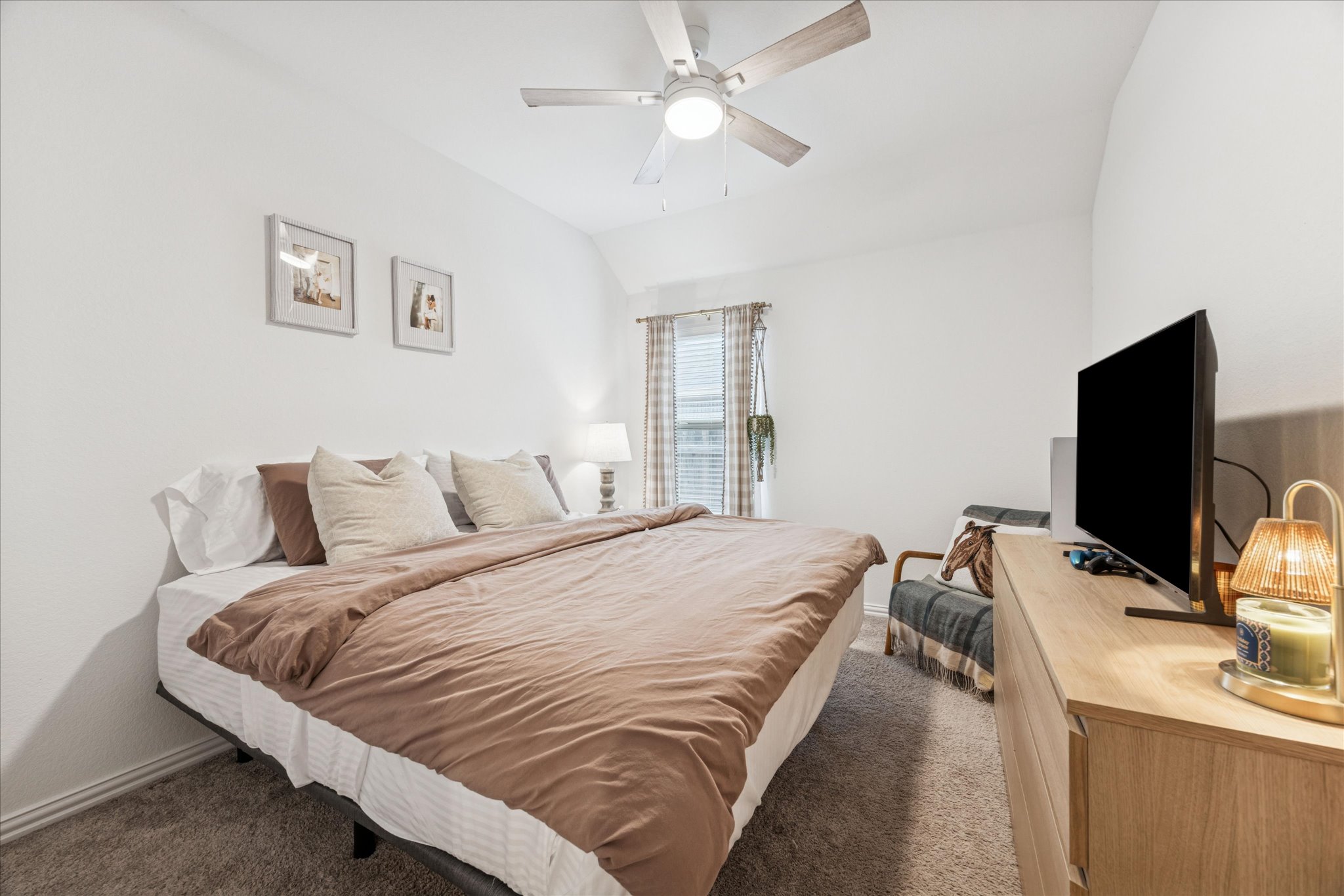540 Sugar Cane Buda, TX 78610 - Photo 6 of 11 Bedroom with vaulted ceiling, dark colored carpet, and ceiling fan
