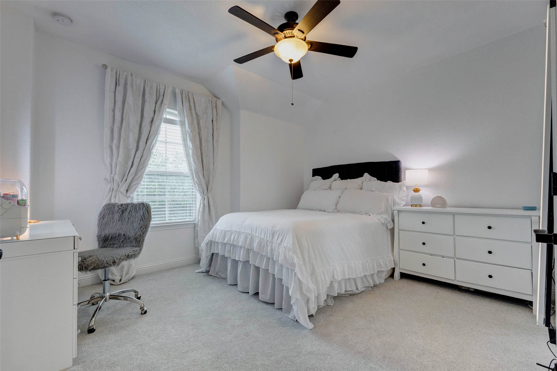 29903 Spring Side Court Fulshear, TX 77406 - Photo 41 of 50 Guest bedroom three upstairs offers plush newer carpet, soft natural light, a ceiling fan, and plenty of room for a full bedroom setup or flexible use as a study or hobby space.