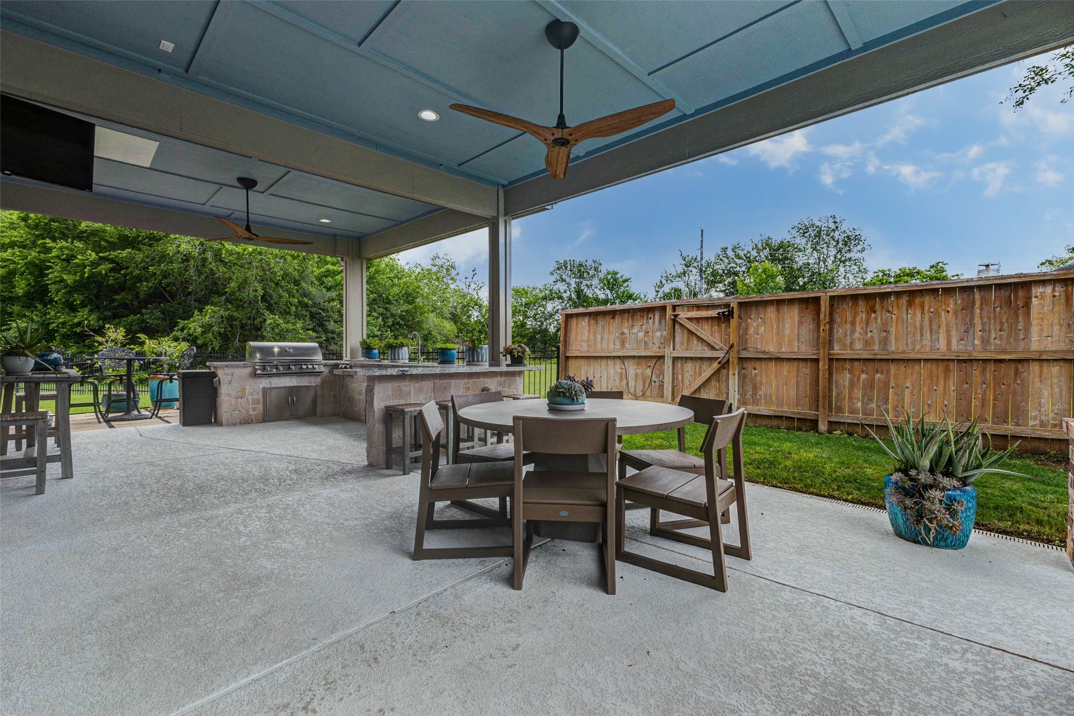 29903 Spring Side Court Fulshear, TX 77406 - Photo 46 of 50 Whether hosting weekend barbecues or quiet evenings outdoors, this oversized covered patio offers ample room for dining and lounging.