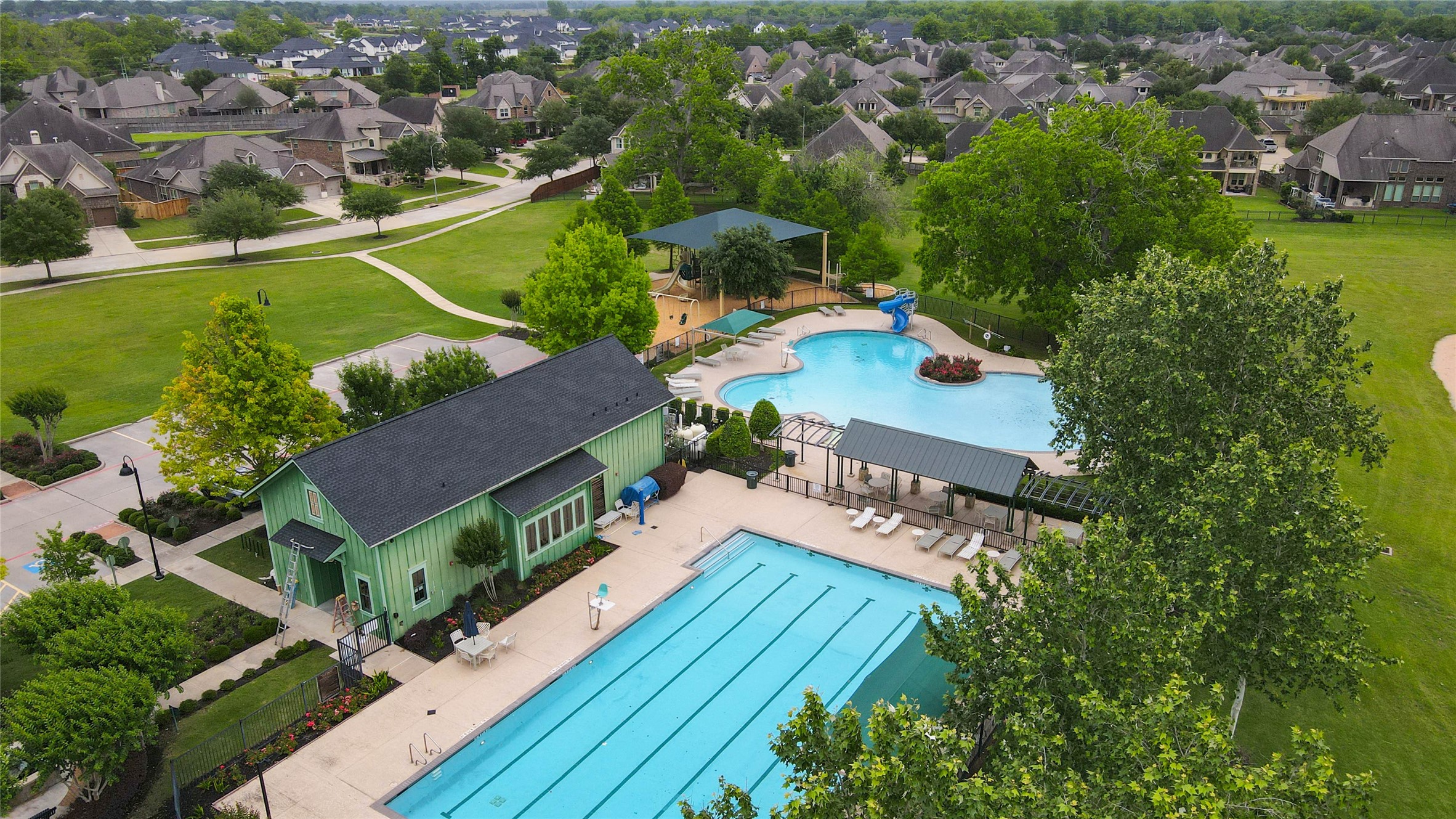 29903 Spring Side Court Fulshear, TX 77406 - Photo 49 of 50 Residents enjoy access to outstanding community amenities including a beautiful clubhouse, resort-style pool, lap pool, splash area, playground, and expansive greenspaces designed for recreation and gathering.