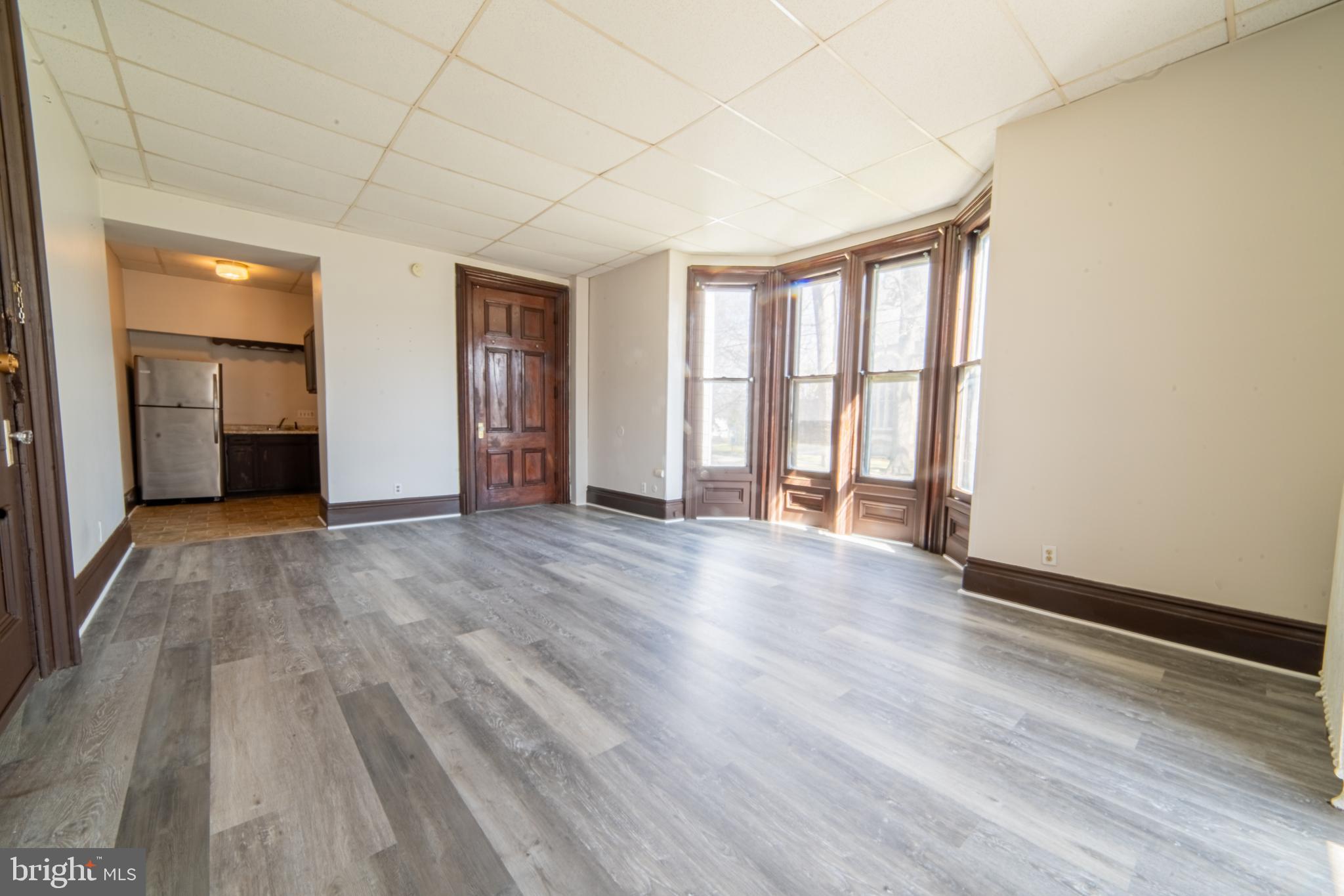125 West Commerce Street, Unit 2 Bridgeton, NJ 08302 - Photo 6 of 7 wooden floor in an empty room with a window