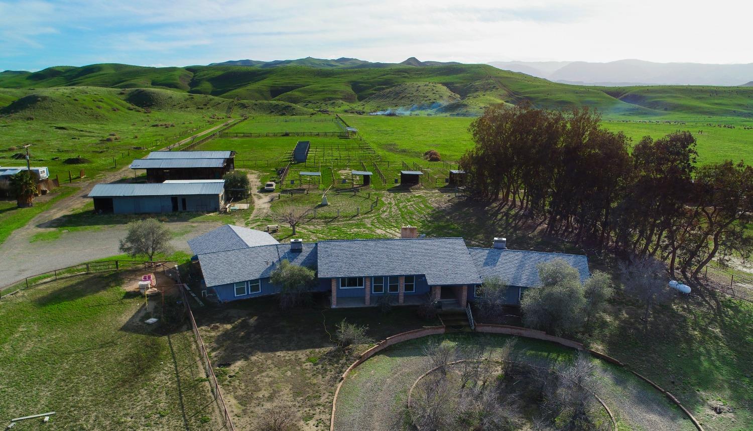 an aerial view of a house with pool big yard and mountain view