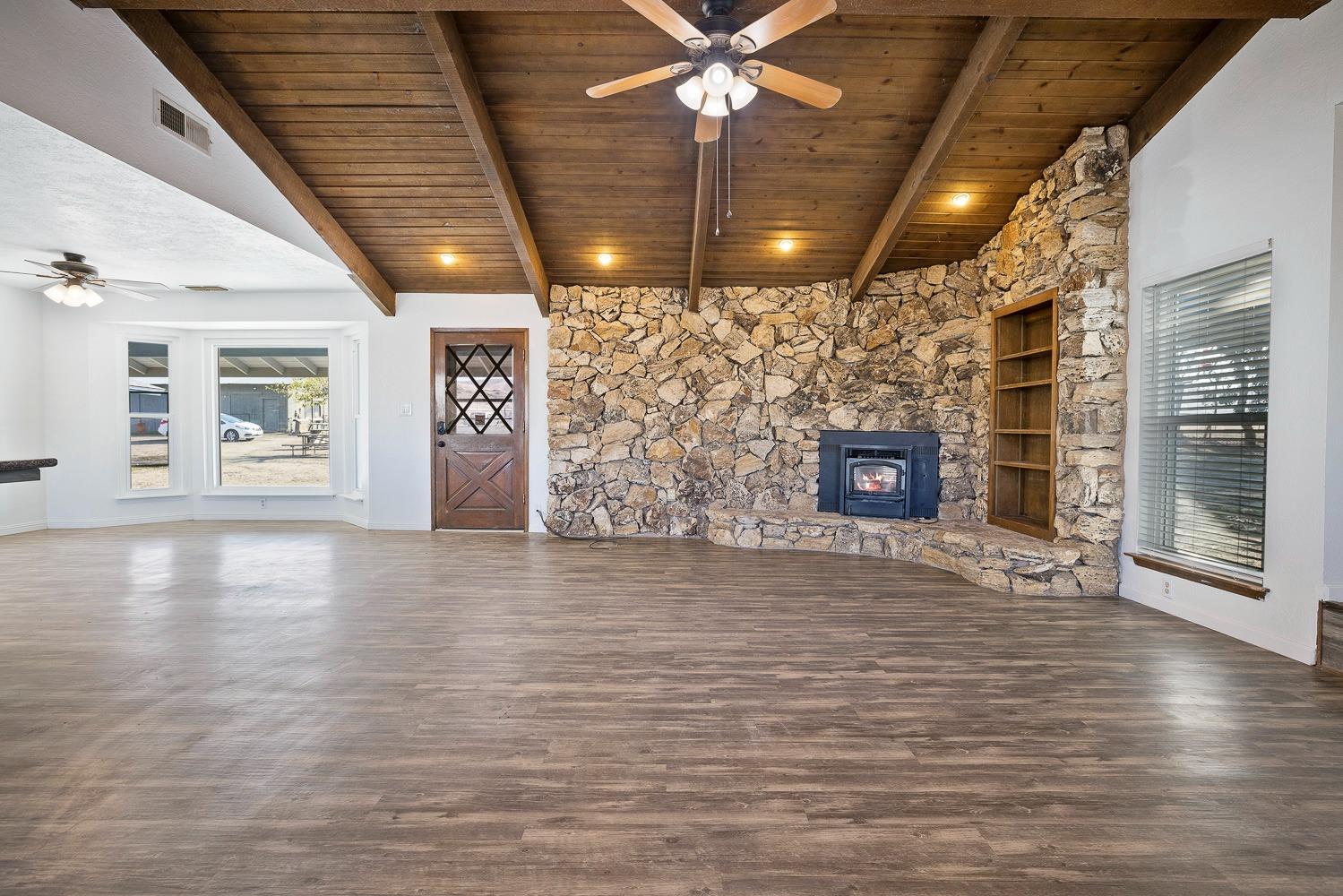 43036 Jacalitos Creek Road Coalinga, CA 93210 - Photo 13 of 85 a view of an empty room with wooden floor and a fireplace