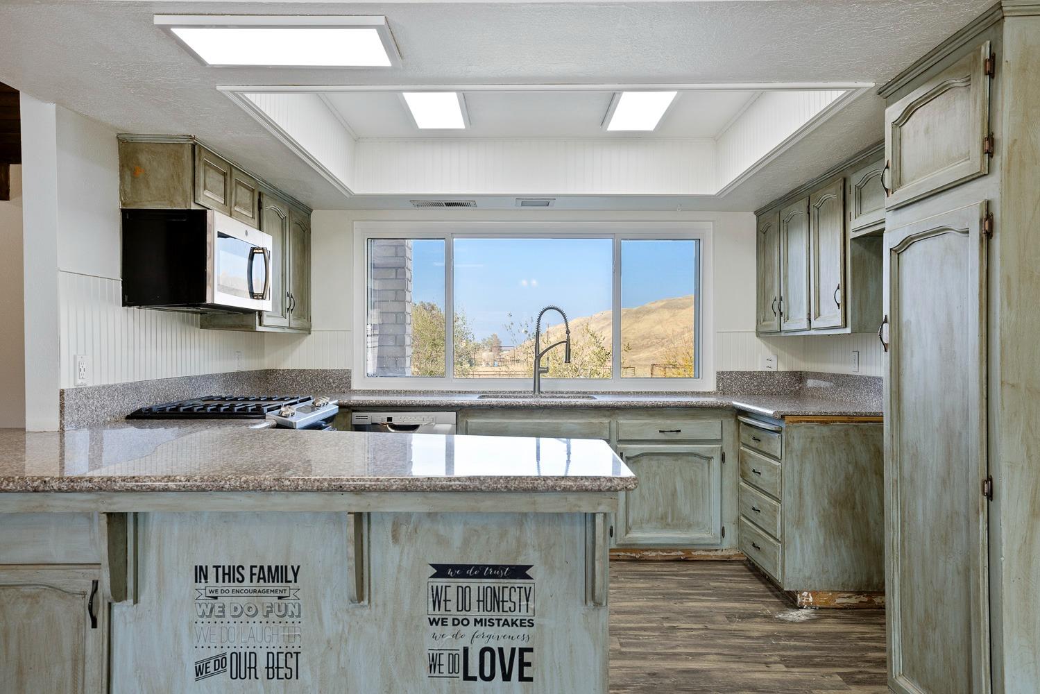 43036 Jacalitos Creek Road Coalinga, CA 93210 - Photo 16 of 85 a kitchen with stainless steel appliances granite countertop a sink stove and microwave