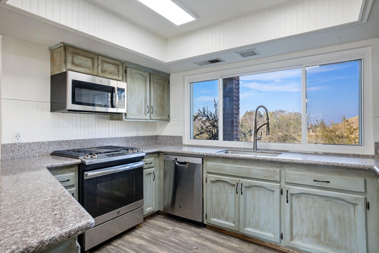 43036 Jacalitos Creek Road Coalinga, CA 93210 - Photo 18 of 85 a kitchen with sink stove and microwave