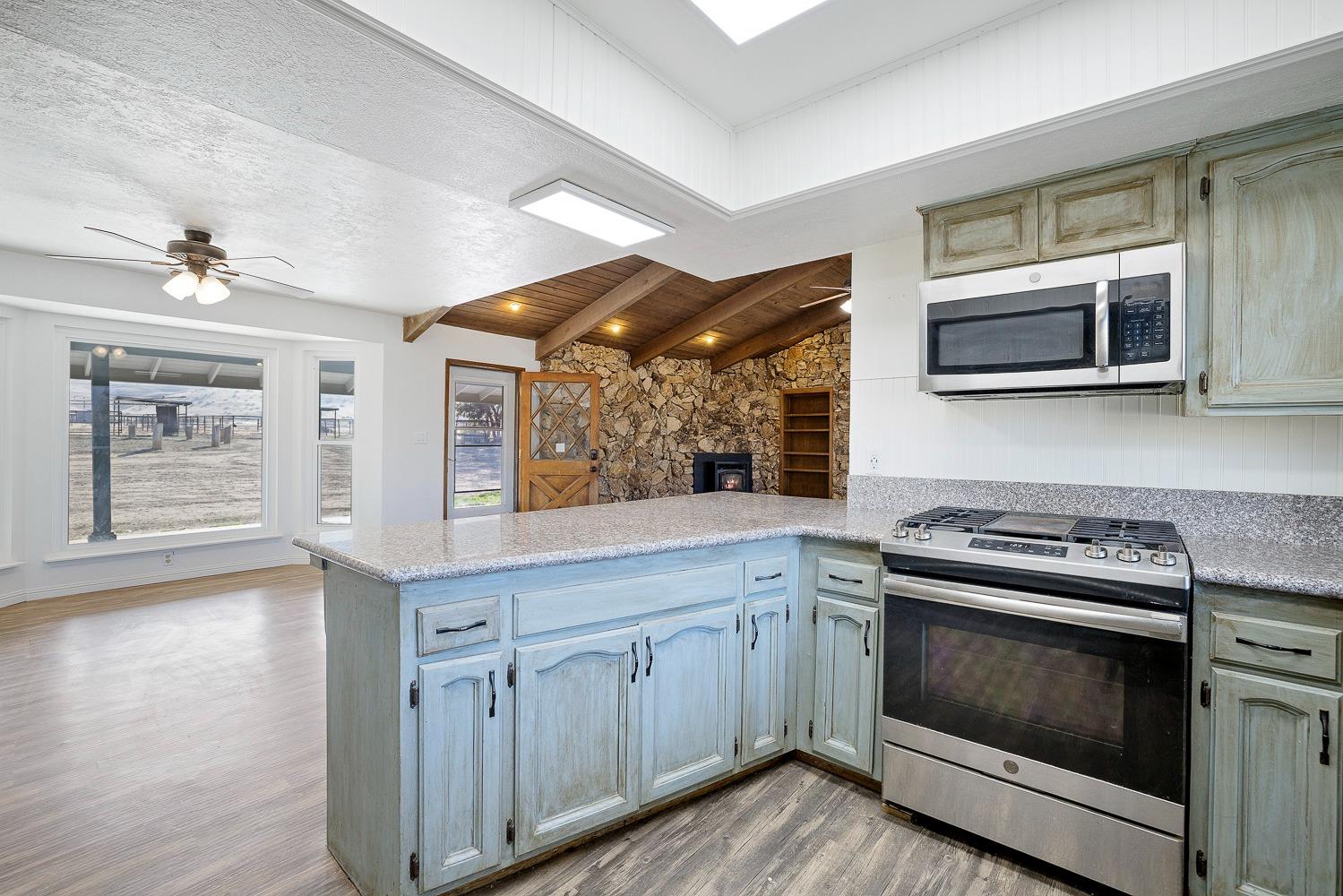 43036 Jacalitos Creek Road Coalinga, CA 93210 - Photo 20 of 85 a kitchen with cabinets appliances and a wooden floor