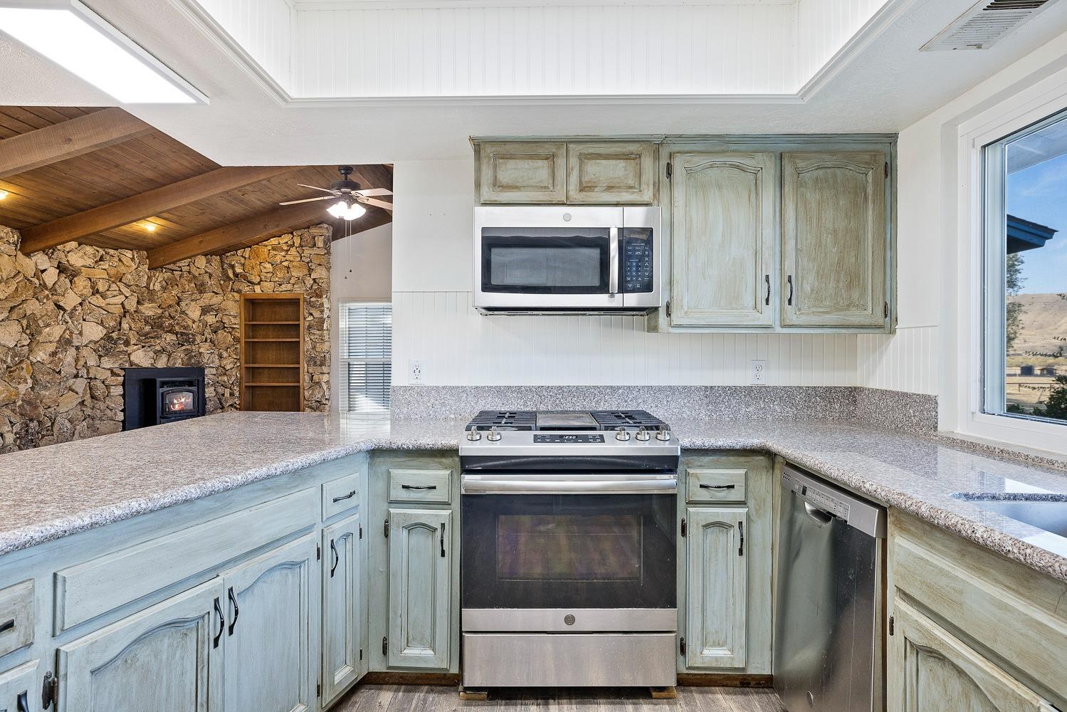 43036 Jacalitos Creek Road Coalinga, CA 93210 - Photo 21 of 85 a kitchen with a stove microwave and sink