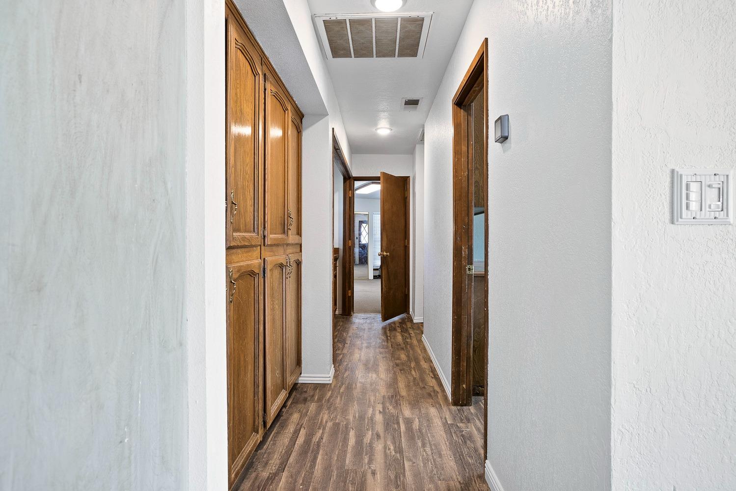 43036 Jacalitos Creek Road Coalinga, CA 93210 - Photo 22 of 85 a view of a hallway with wooden floor and staircase