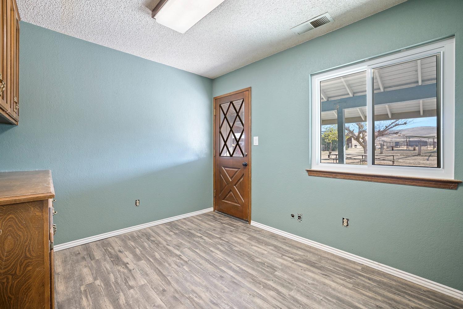 43036 Jacalitos Creek Road Coalinga, CA 93210 - Photo 24 of 85 a view of an empty room with window and wooden floor
