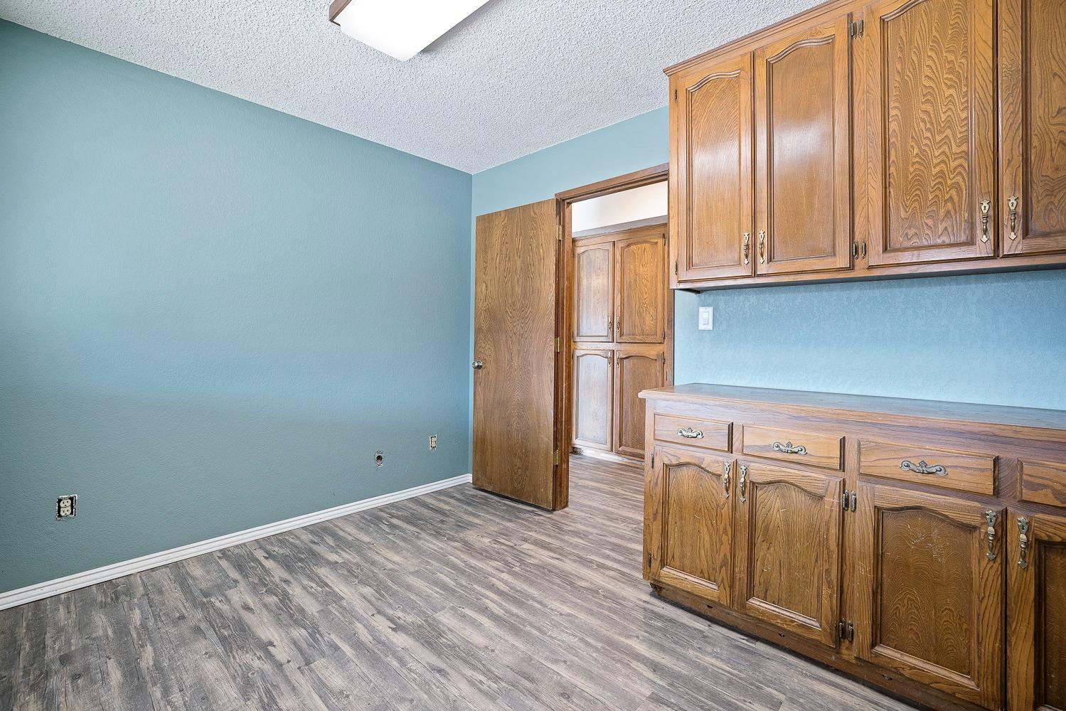 43036 Jacalitos Creek Road Coalinga, CA 93210 - Photo 26 of 85 a view of an empty room with wooden floor and a window