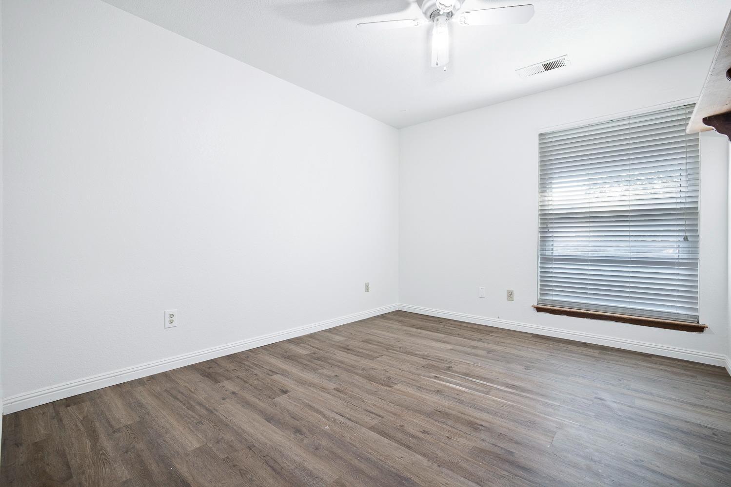 43036 Jacalitos Creek Road Coalinga, CA 93210 - Photo 27 of 85 a view of an empty room with wooden floor and a window