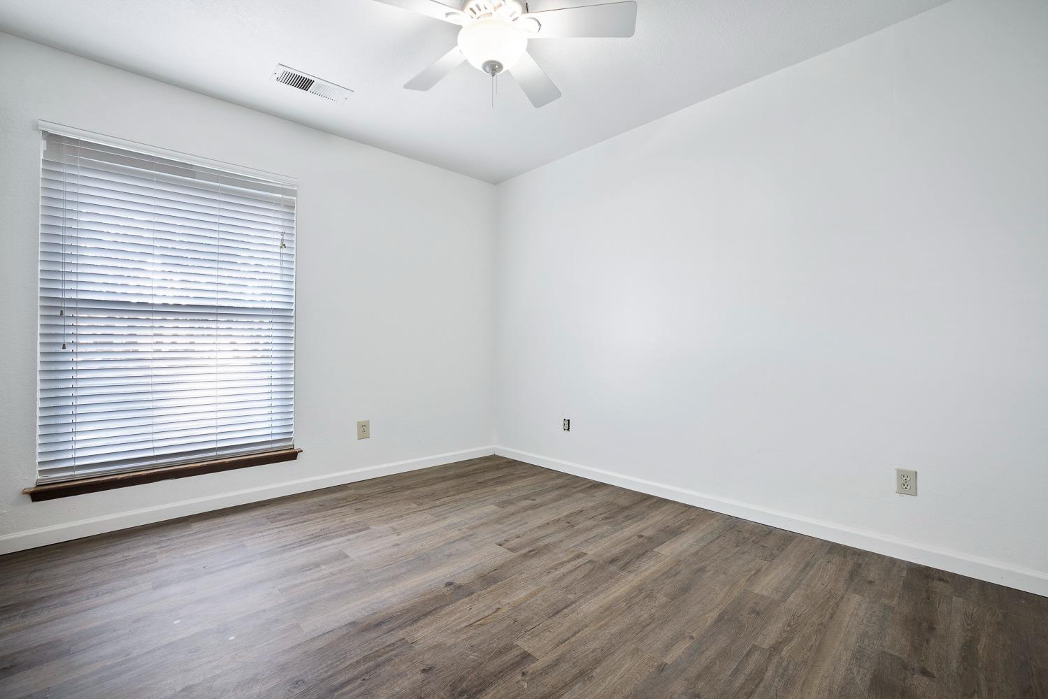 43036 Jacalitos Creek Road Coalinga, CA 93210 - Photo 33 of 85 an empty room with wooden floor and windows
