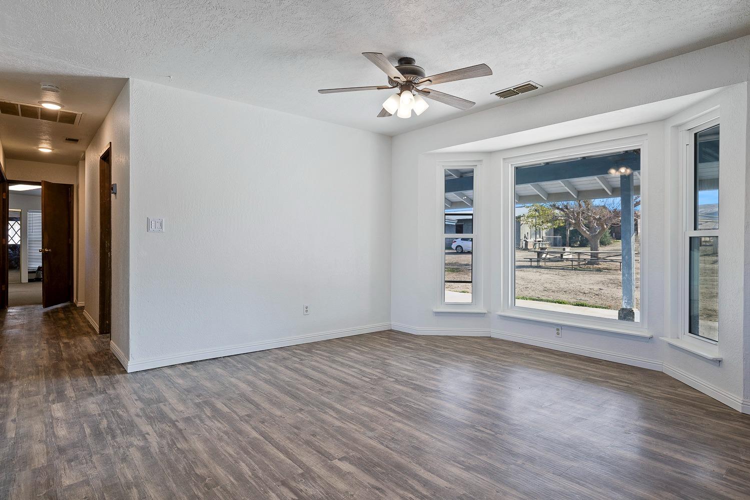 43036 Jacalitos Creek Road Coalinga, CA 93210 - Photo 10 of 85 a view of an empty room with wooden floor and a window