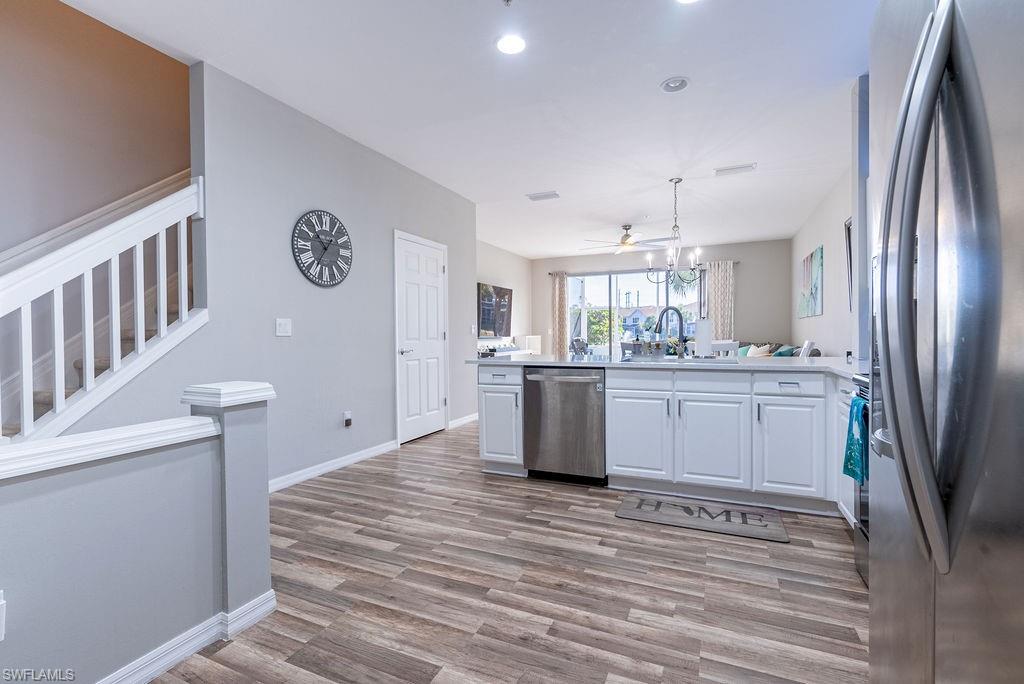 15792 Marcello Circle, Unit 182 Naples, FL 34110 - Photo 14 of 50 a large white kitchen with a sink a refrigerator and a stove