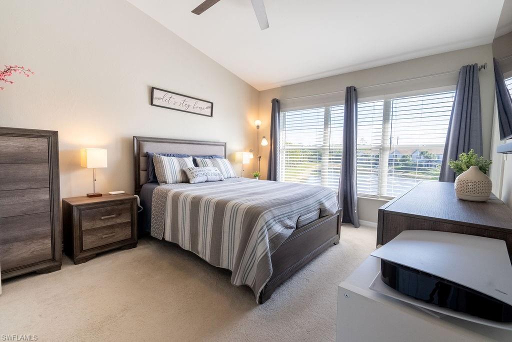 15792 Marcello Circle, Unit 182 Naples, FL 34110 - Photo 16 of 50 a spacious bedroom with a bed and glass door