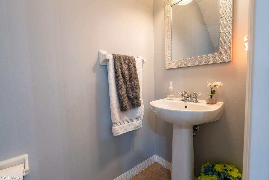 15792 Marcello Circle, Unit 182 Naples, FL 34110 - Photo 18 of 50 a bathroom with a sink and mirror