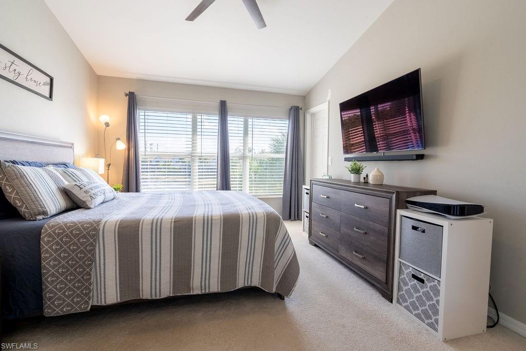 15792 Marcello Circle, Unit 182 Naples, FL 34110 - Photo 20 of 50 a bedroom with a bed and a dresser