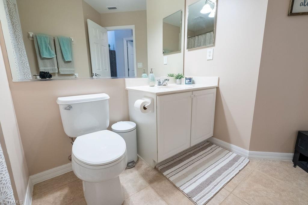 15792 Marcello Circle, Unit 182 Naples, FL 34110 - Photo 21 of 50 a bathroom with a sink a toilet and mirror