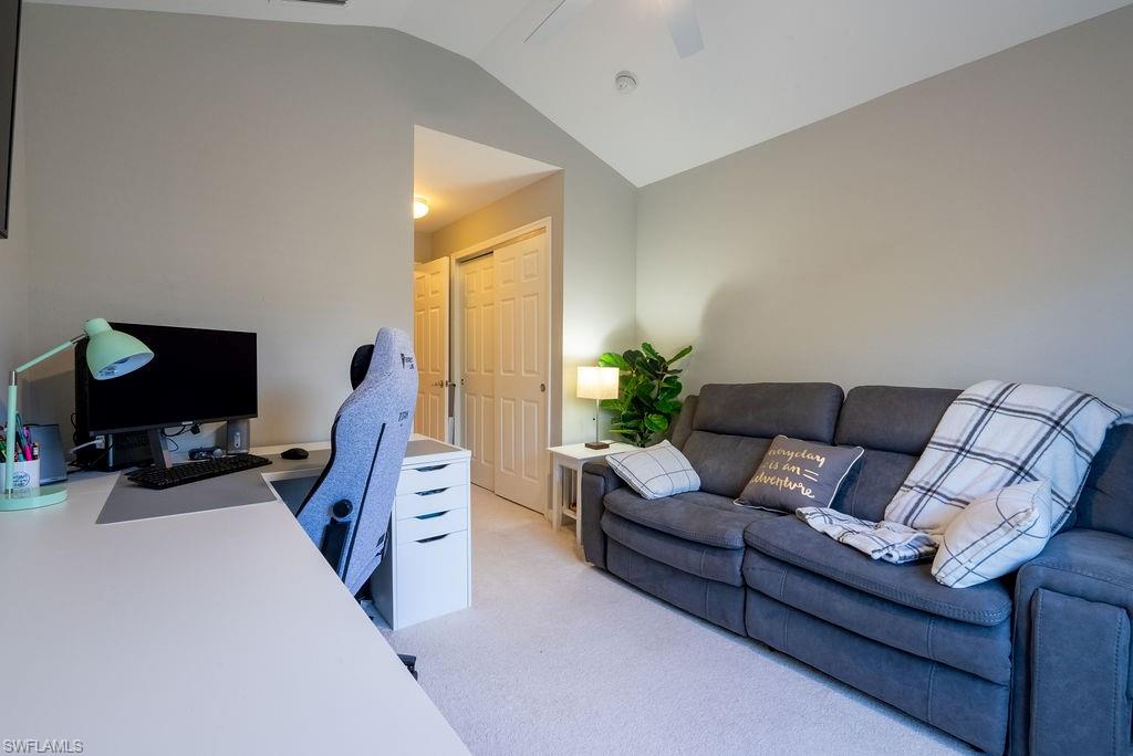 15792 Marcello Circle, Unit 182 Naples, FL 34110 - Photo 24 of 50 a living room with furniture a flat screen tv and a window