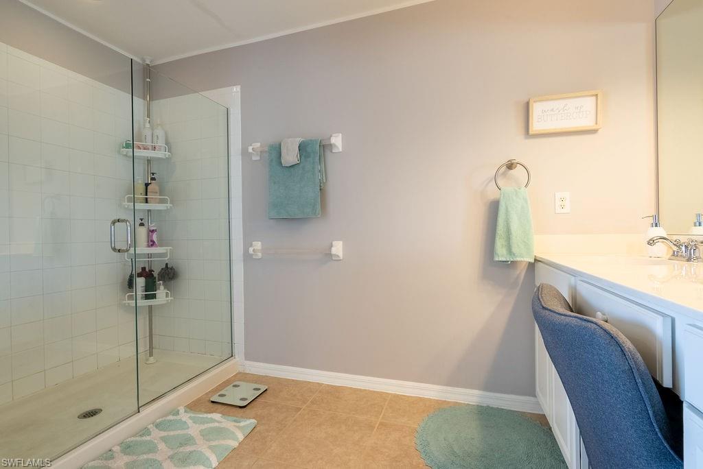 15792 Marcello Circle, Unit 182 Naples, FL 34110 - Photo 29 of 50 a bathroom with a sink and shower