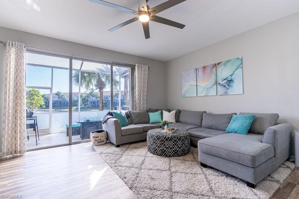 15792 Marcello Circle, Unit 182 Naples, FL 34110 - Photo 3 of 50 a living room with furniture and a large window