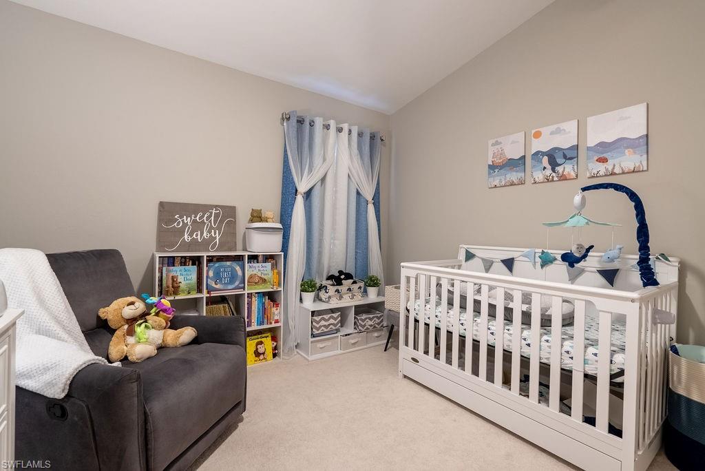 15792 Marcello Circle, Unit 182 Naples, FL 34110 - Photo 30 of 50 a bedroom with furniture and a book shelf