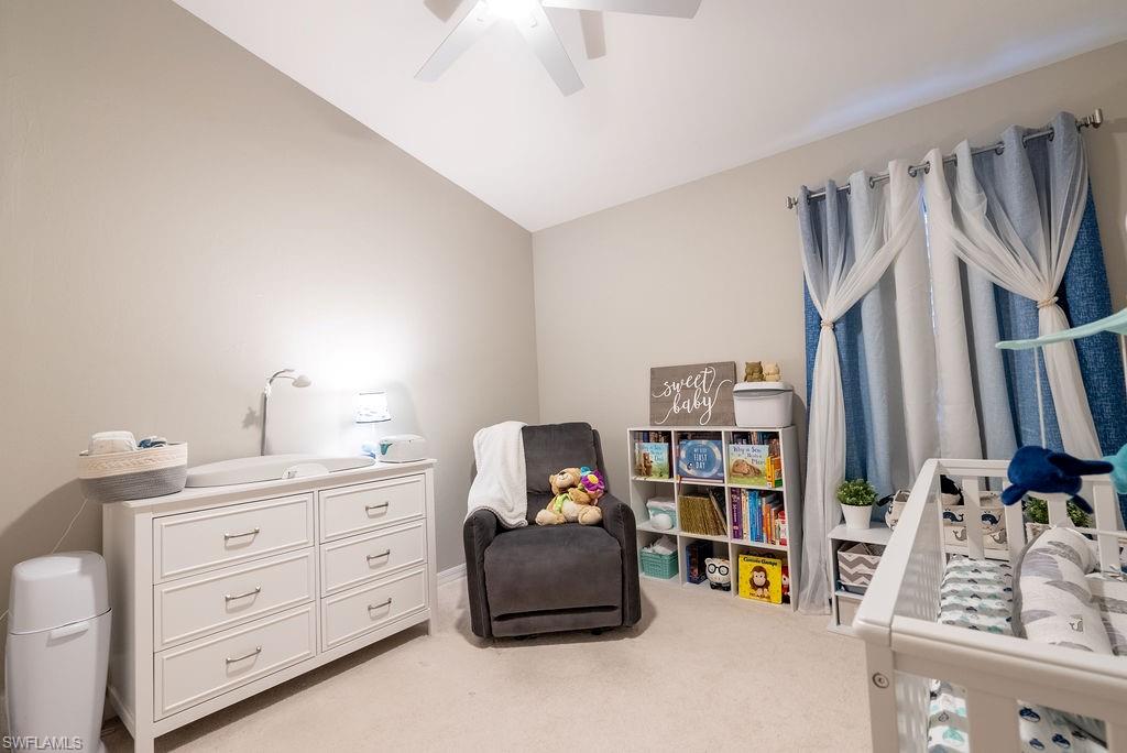 15792 Marcello Circle, Unit 182 Naples, FL 34110 - Photo 31 of 50 a bedroom with a bed and a book shelf