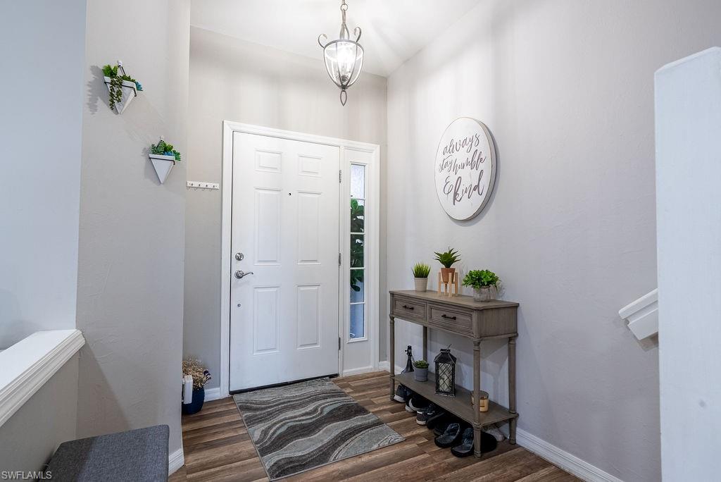 15792 Marcello Circle, Unit 182 Naples, FL 34110 - Photo 39 of 50 a living room with couch and wooden floor
