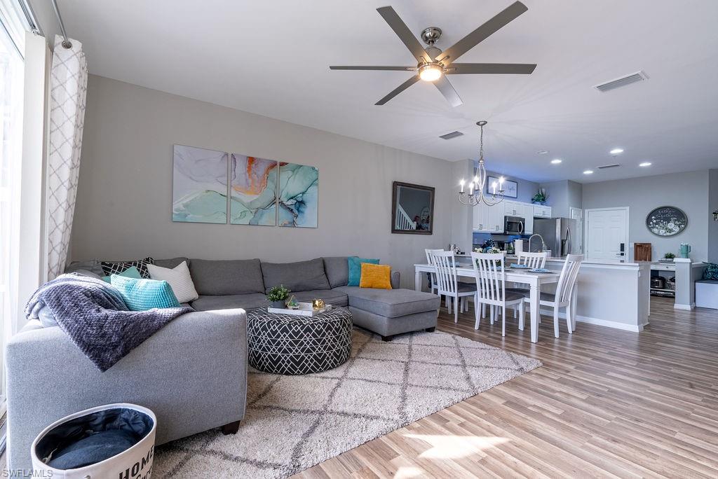 15792 Marcello Circle, Unit 182 Naples, FL 34110 - Photo 6 of 50 a living room with furniture and kitchen view