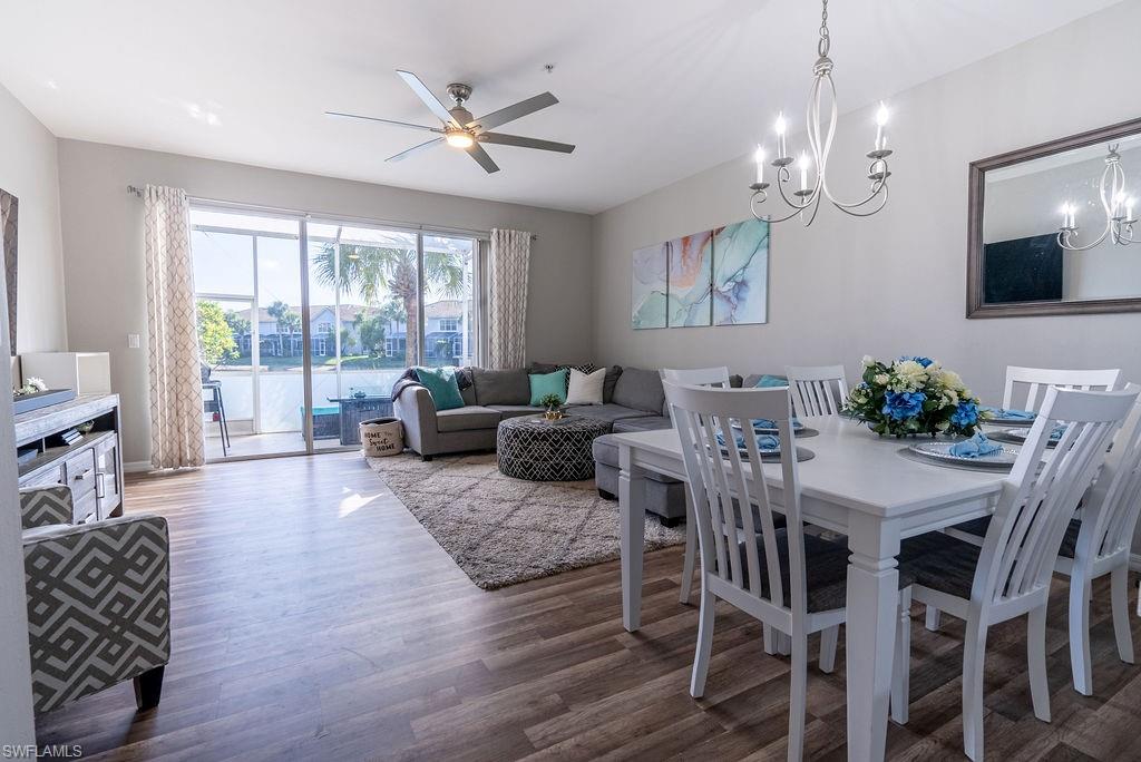 15792 Marcello Circle, Unit 182 Naples, FL 34110 - Photo 8 of 50 a living room with furniture chandelier and a flat screen tv