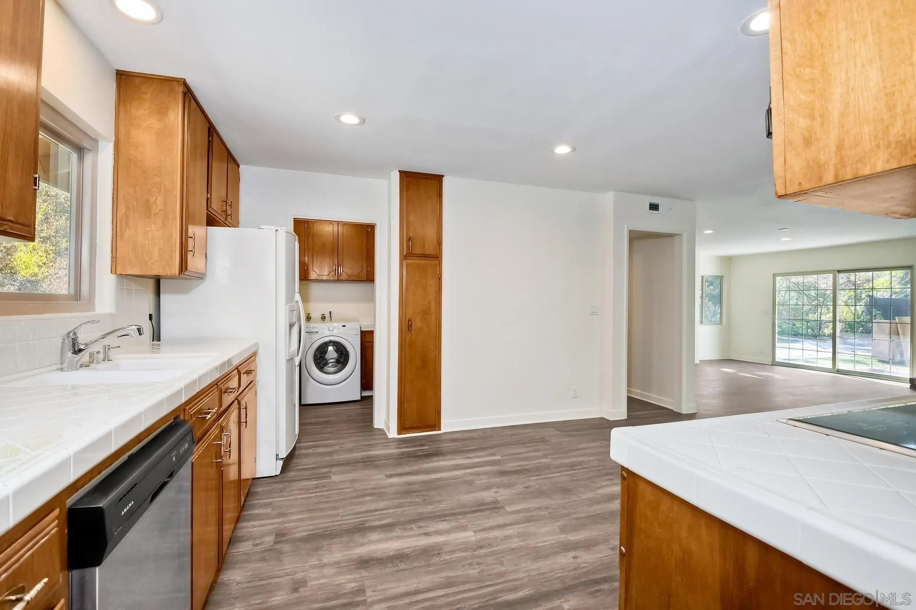 13541 Willow Run Road Poway, CA 92064 - Photo 11 of 40 a kitchen with a sink a stove and a refrigerator