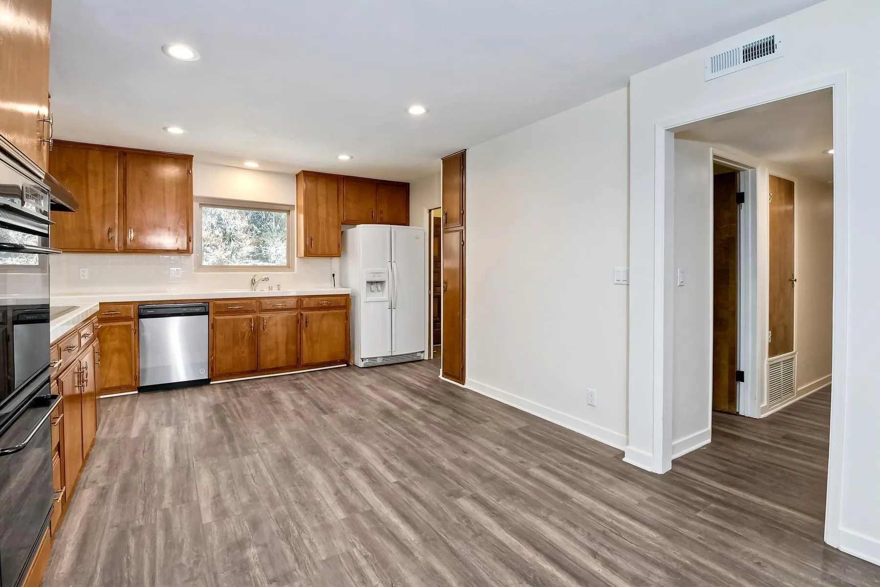 13541 Willow Run Road Poway, CA 92064 - Photo 13 of 40 a kitchen with stainless steel appliances granite countertop a refrigerator and a stove top oven